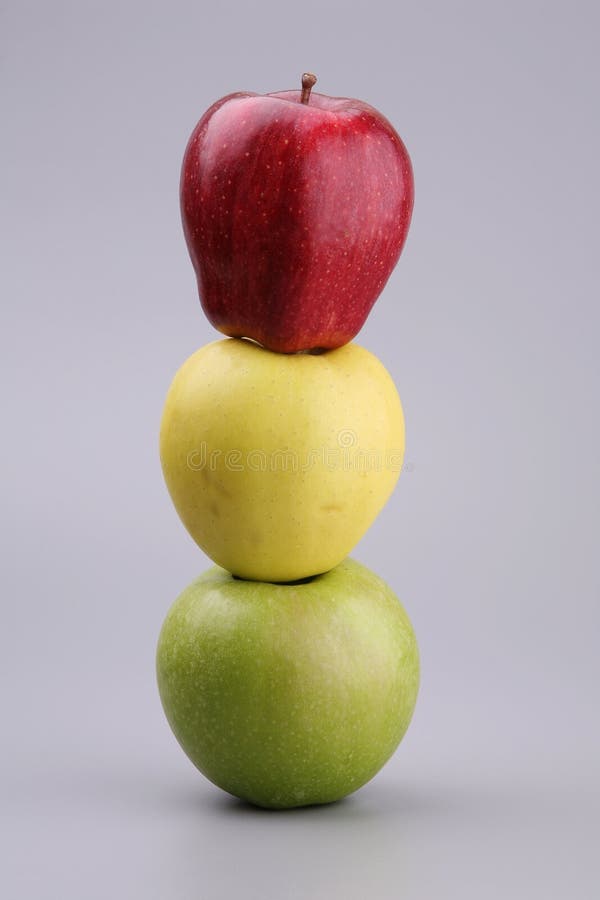 Three apples on a grey background