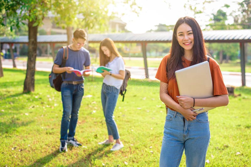 Three Asian young campus people tutoring and preparing for final royalty free stock photo Three Asian young campus people tutoring and preparing for final royalty free stock photo