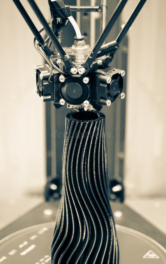 The three-axis 3d printer creates an object in the form of a black vase close-up stock images