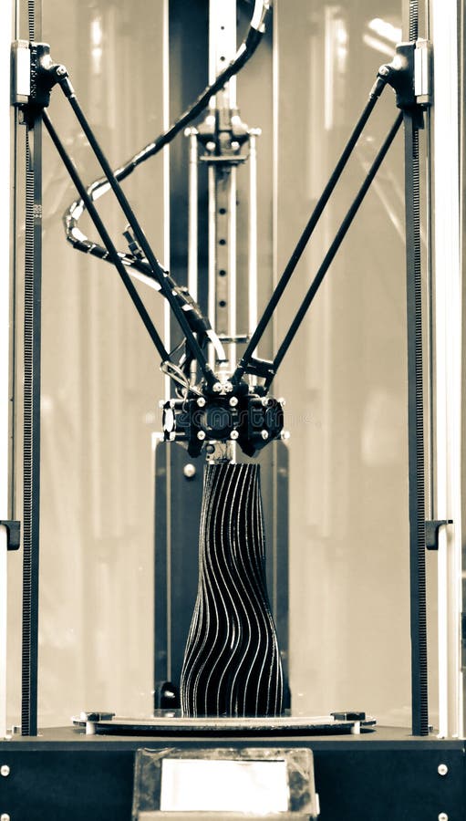 The three-axis 3d printer creates an object in the form of a black vase stock images