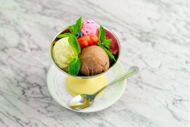 Three Balls of Ice Cream with Berries and Mint, a Beautiful Serving