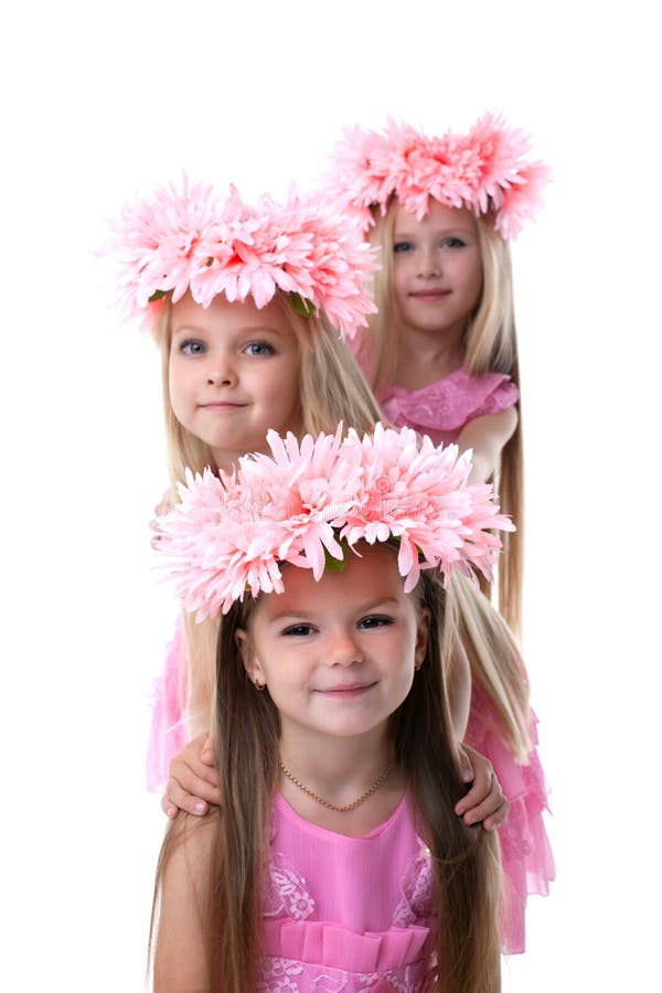 Three beautiful little girls with pink wreaths