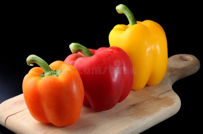 Three Bell Peppers on a cutting board