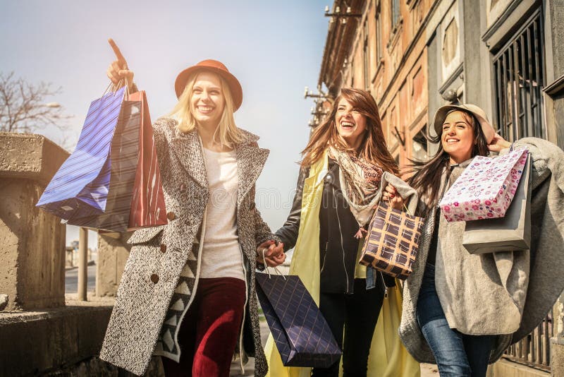 Three best friends walking on the street . Young girl showing a stock photography Three best friends walking on the street . Young girl showing a stock photography