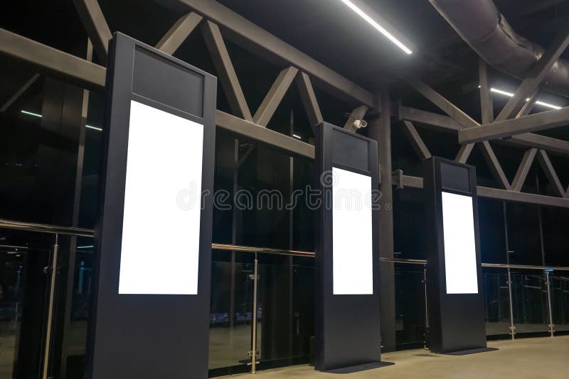Three Black Electronic Kiosks with Vertical Blank Interactive White