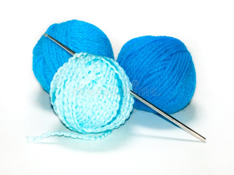 Three blue yarns and a crochet hook