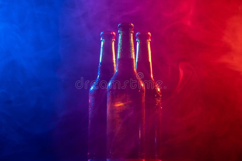 Three Bottles of Beer in a Bluepink Mist. Stock Photo Image of drink