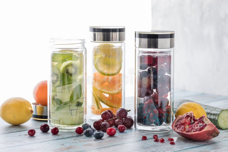 Three bottles of different fruit and vegetable infused flavoured water. stock image Three bottles of different fruit and vegetable infused flavoured water. stock image