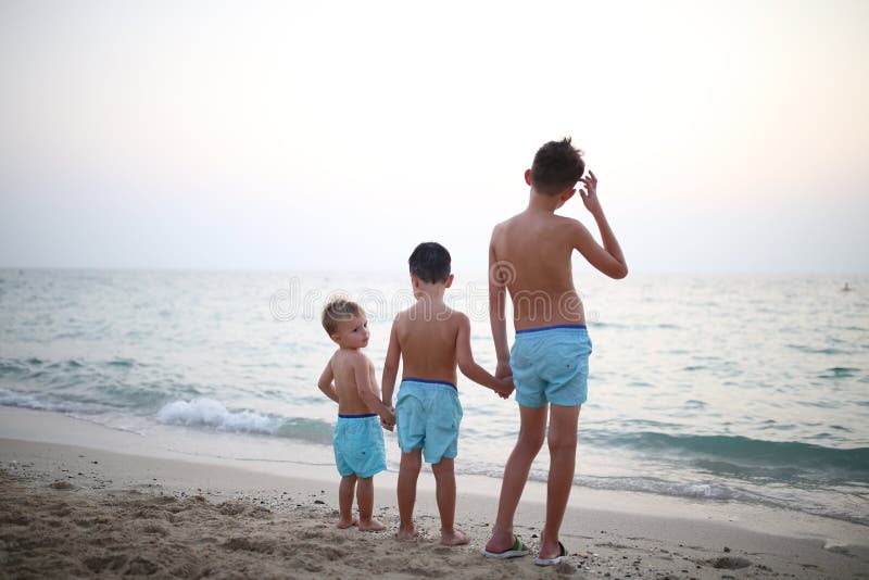 Three brothers on the beach, view from the back royalty free stock image Three brothers on the beach, view from the back royalty free stock image