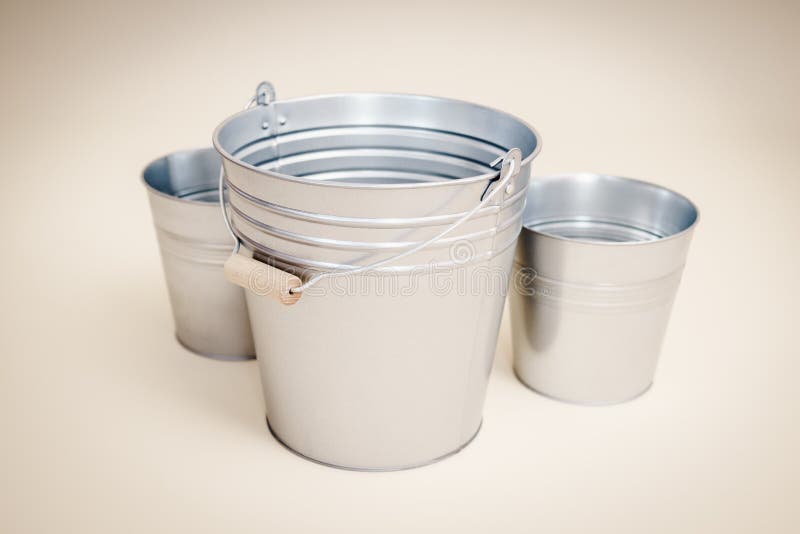 Three Different Colored Buckets With Handles Stock Photo