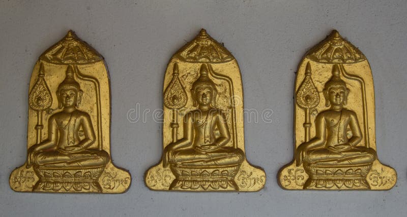 Three Buddha on Gray wall background.