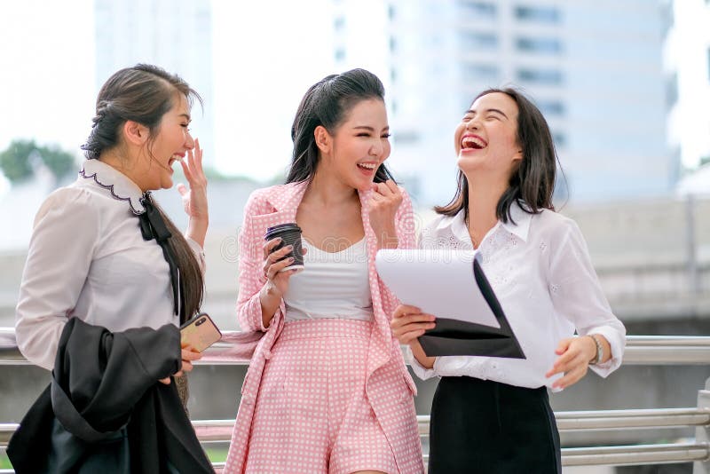 Three business Asian girls are acting as happy and exciting outside the office during day time stock photography Three business Asian girls are acting as happy and exciting outside the office during day time stock photography