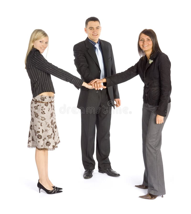 Three business people, one man and two women join hands in a semi-circle, symbolizing partnership. Three business people, one man and two women join hands in a semi-circle, symbolizing partnership.