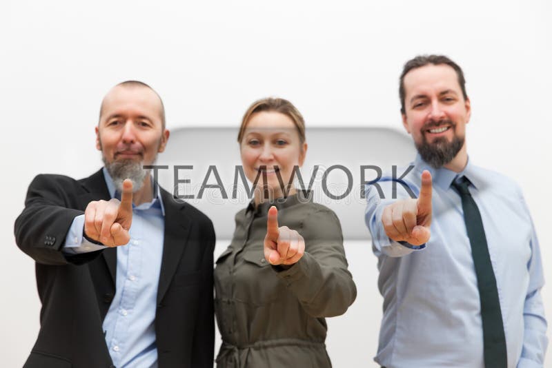 Three business people touching a virtual button royalty free stock photo Three business people touching a virtual button royalty free stock photo