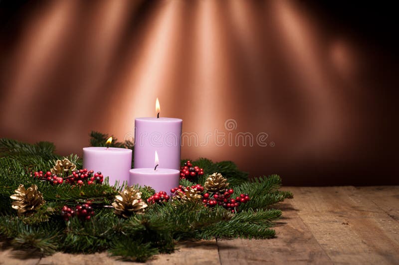 Three candles in an advent flower arrangement