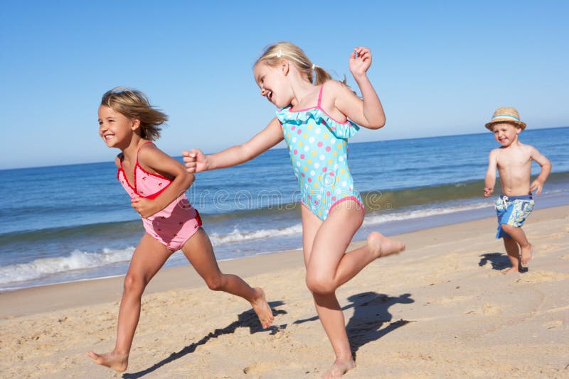 Three Children Running Along Beach royalty free stock photography Three Children Running Along Beach royalty free stock photography