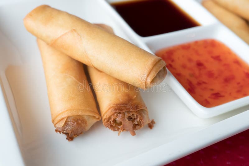 Three Chinese pancakes stuffed on a white plate with sweet chili sauce. Shallow depth of field royalty free stock photos Three Chinese pancakes stuffed on a white plate with sweet chili sauce. Shallow depth of field royalty free stock photos