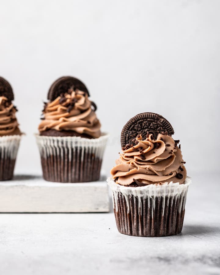Three chocolate cupcakes stock photo. Image of muffin - 179304232