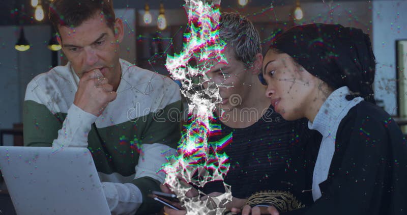 Three colleagues collaborating around laptop in tech workspace, displaying floating network graphic stock footage
