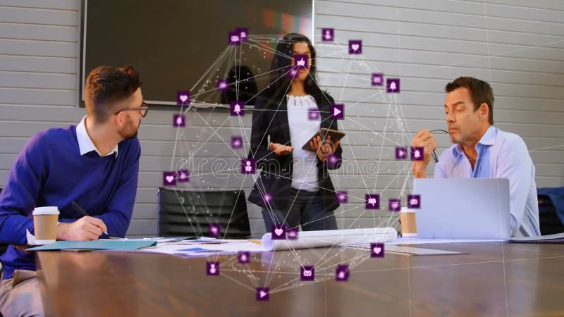 Three colleagues discussing business strategy around table, showing purple network icons stock footage