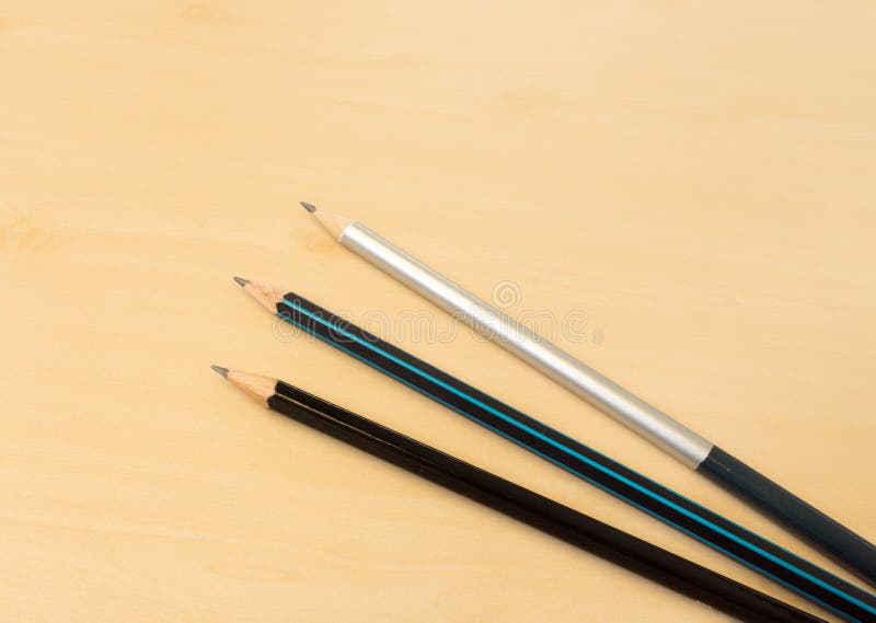 Three Color Sharp Pencils Placed on Light Brown Wooden Table Tex