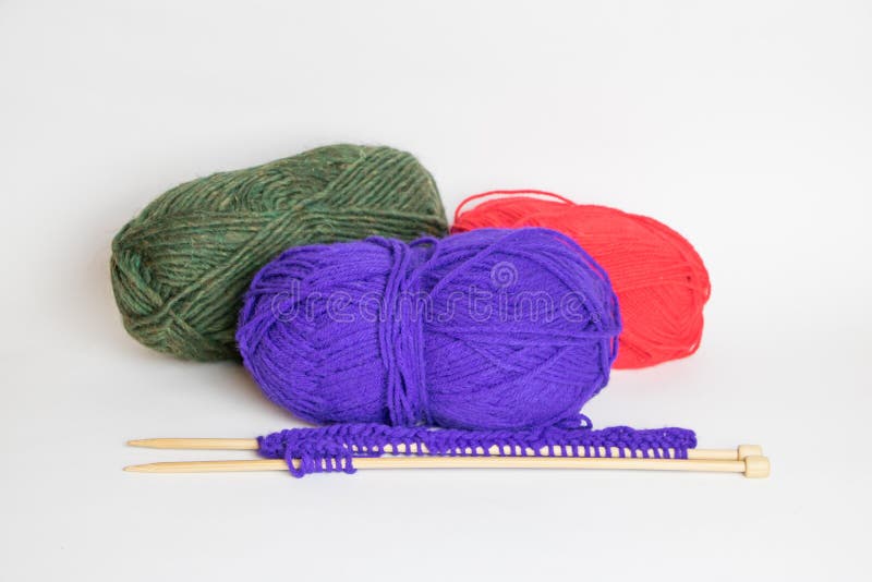Three Colorful Balls of Yarn with Two Knitting Needles Stock Photo