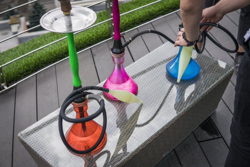 Three Colors Hookahs on Table in Hookah Lounge in a Day. Stock Photo