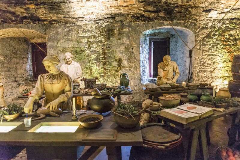 Three cooks prepare ingredients in the Great Kitchen for the next meal, Stirling Castle royalty free stock photos Three cooks prepare ingredients in the Great Kitchen for the next meal, Stirling Castle royalty free stock photos