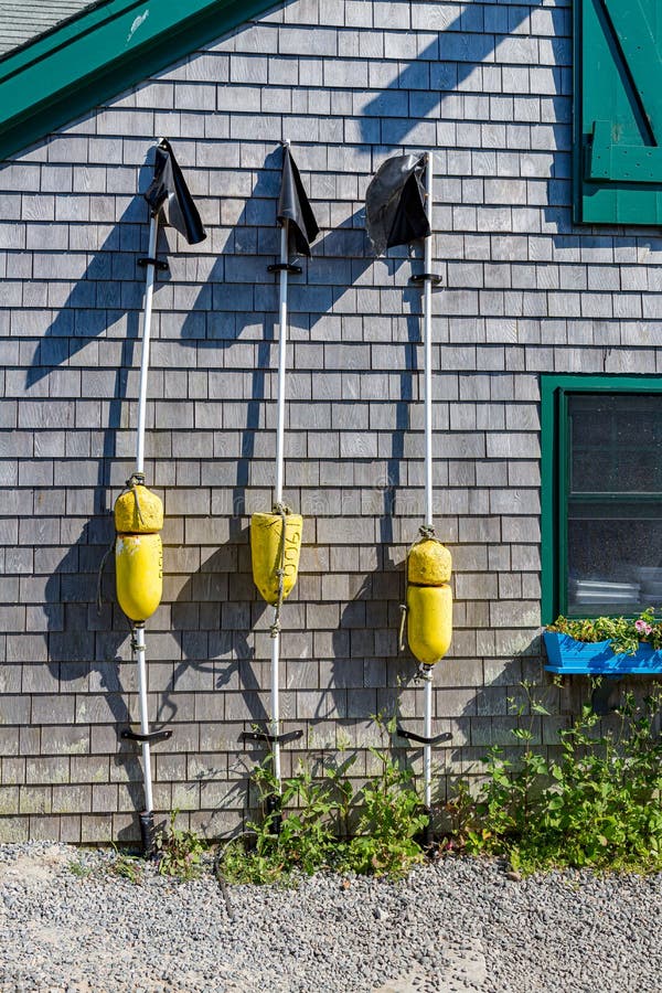 Three Crab Trap Buoy Markers Leaning Up Against Building in Martha
