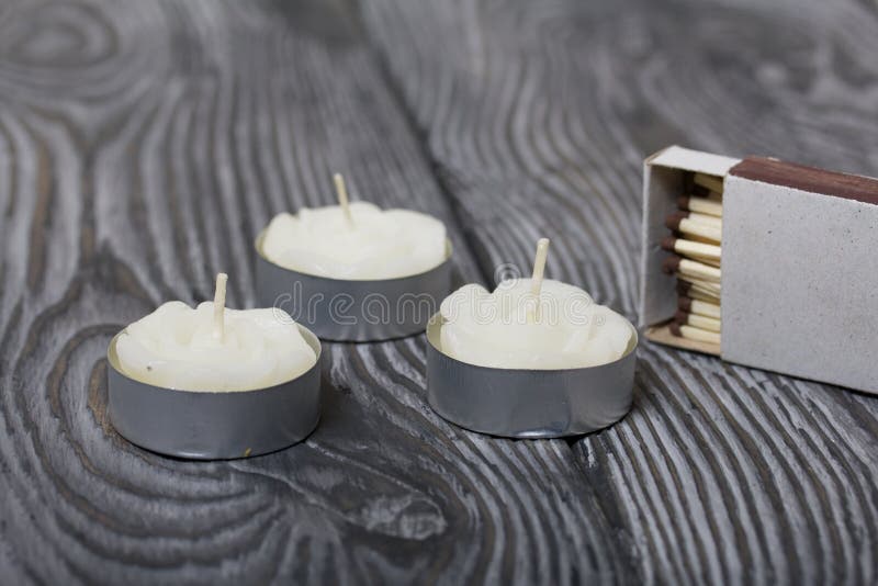 Decorative Candles Arranged in a Row. on a Pink Background Stock Photo