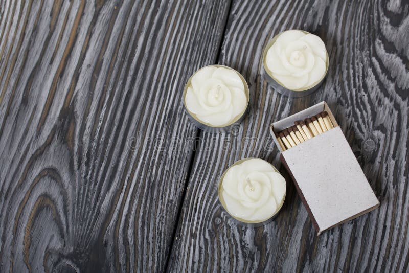 Decorative Candles and Matchboxes Arranged in a Row. on a Pink