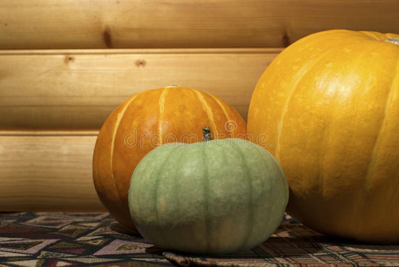 Three different colored pumpkins