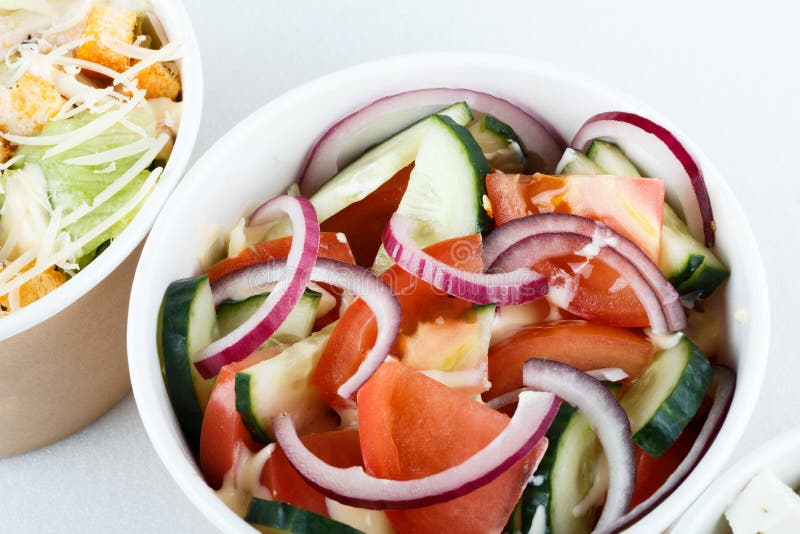 Three dishes top view. fresh, vegetables,. 3 different salads on white background, top view, menu. greeck salad, cesar, salad with onion cucumber and tomates