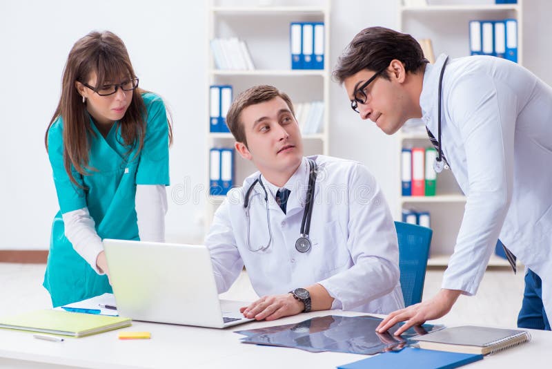 The three doctors discussing scan results of x-ray image