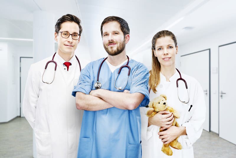 Three doctors group portrait modern clinic frontal team royalty free stock photo