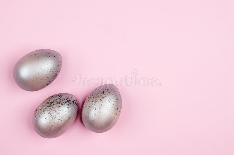 Three Easter Silver Eggs on Pink Background with Copyspace Stock Photo