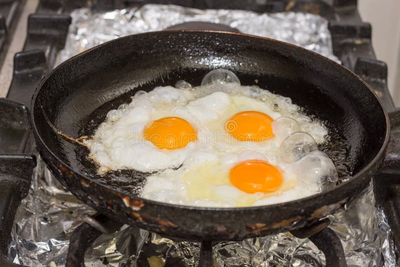 Three Eggs Frying in the Hot Oil Stock Image Image of rustic, kitchen