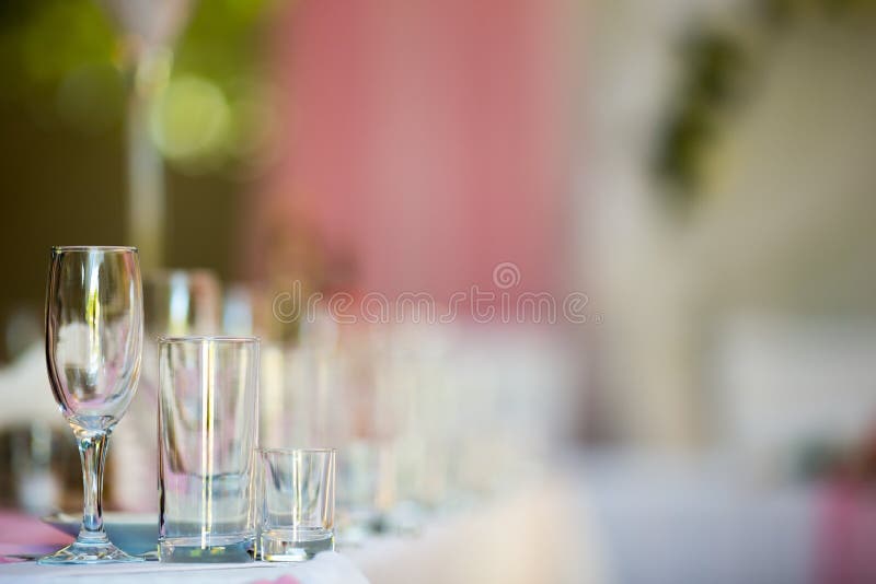 Three empty glasses on banquet table in restaurant.