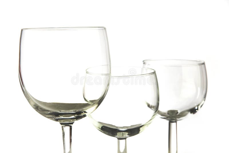 Closeup photo of three empty glasses on white background