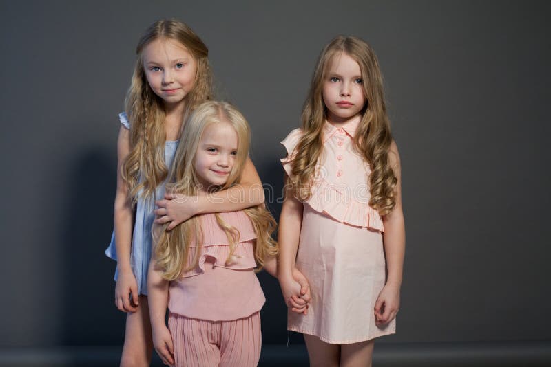 Three fashionable girls girlfriends sisters eat candy lollipop cake royalty free stock photography Three fashionable girls girlfriends sisters eat candy lollipop cake royalty free stock photography