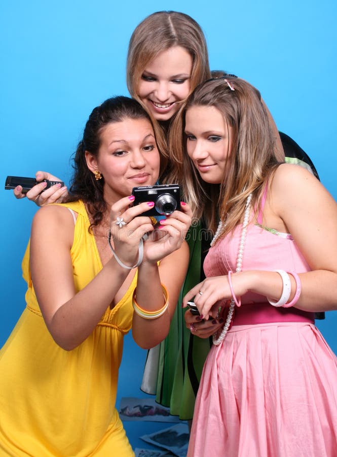 Three female friends with a camera