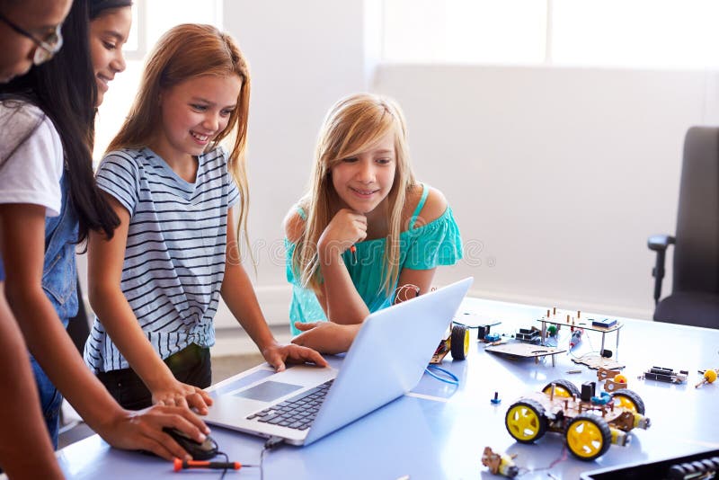 Three Female Students With Teacher Building Robot Vehicle In After School Computer Coding Class stock photography