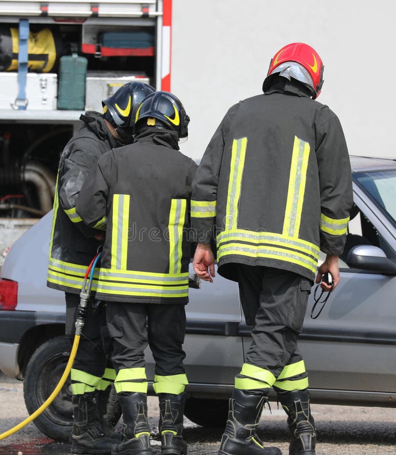 Three firefighter after the road traffic accident stock photo Three firefighter after the road traffic accident stock photo