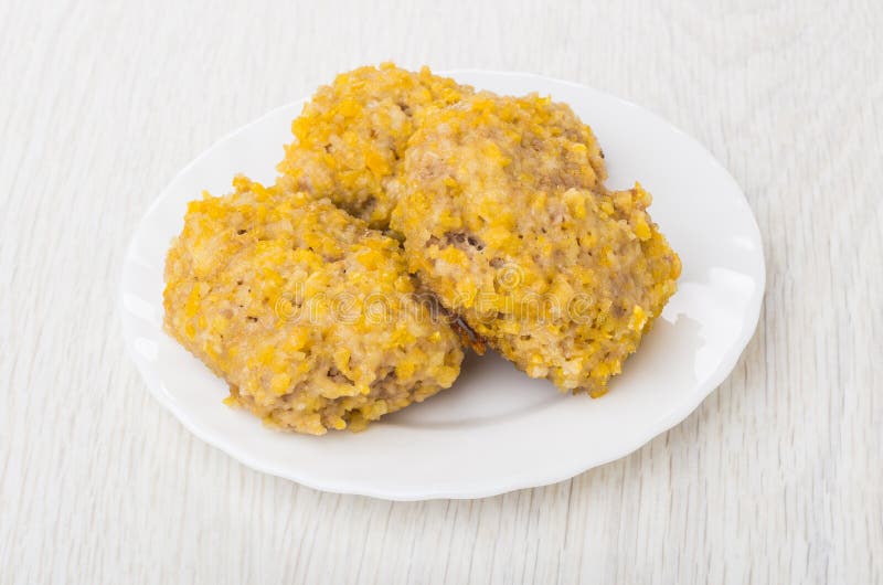 Three Fried Cutlets of Turkey Meat in Plate on Table Stock Photo