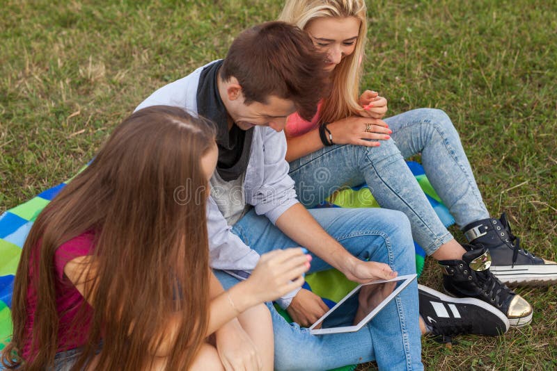 Three Friends Playing Game on Tablet Pc. they Winning Again. Stock Photo Image of playing