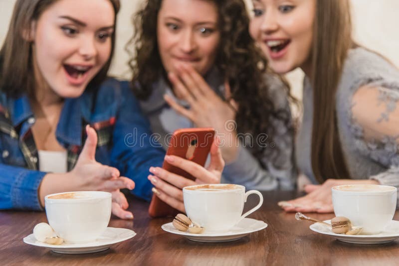 Three Friends Sitting in a Cafe with a Smart Phone and Having a Funny Conversation. Good Girls with Long Beautiful Black Stock Photo - Image of breakfast, adult: 155126744 Three Friends Sitting in a Cafe with a Smart Phone and Having a Funny Conversation. Good Girls with Long Beautiful Black Stock Photo - Image of breakfast, adult: 155126744