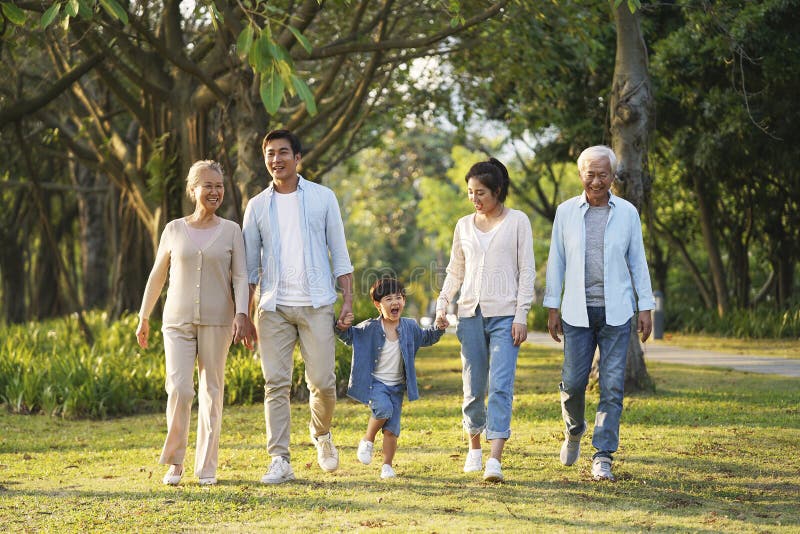 Three generation asian family walking in park royalty free stock images