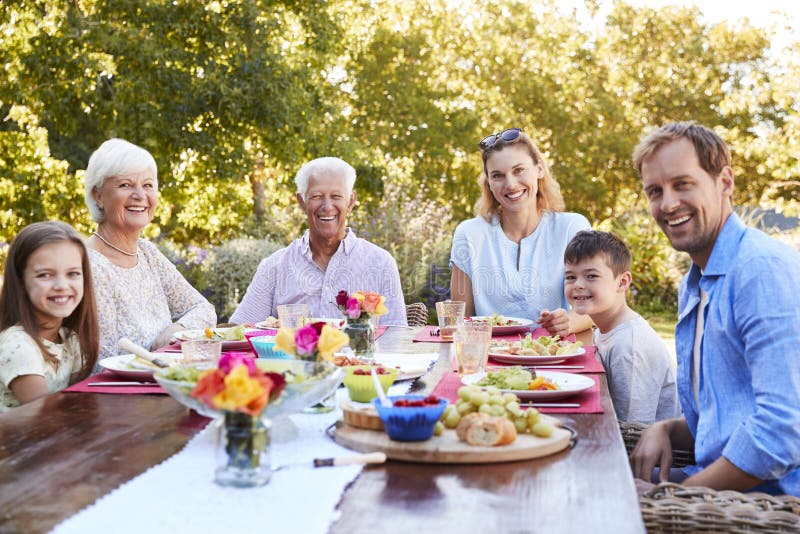 Three Generation Family Having Lunch in the Garden Stock Image - Image ...