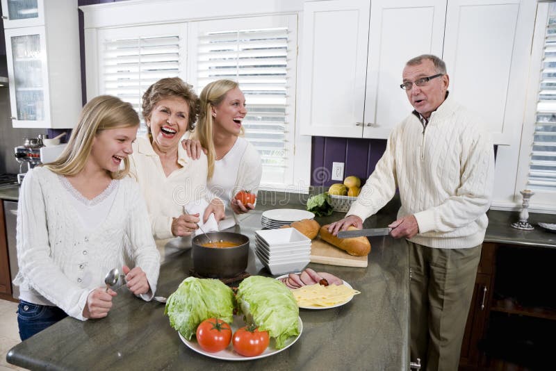 Three generation family in kitchen cooking lunch stock photo Three generation family in kitchen cooking lunch stock photo