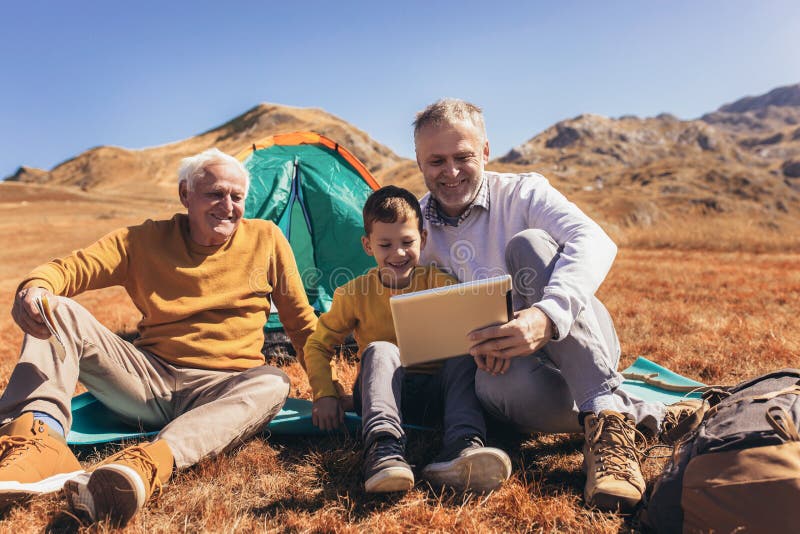 Three generations of family camping together in the autumn royalty free stock photos Three generations of family camping together in the autumn royalty free stock photos